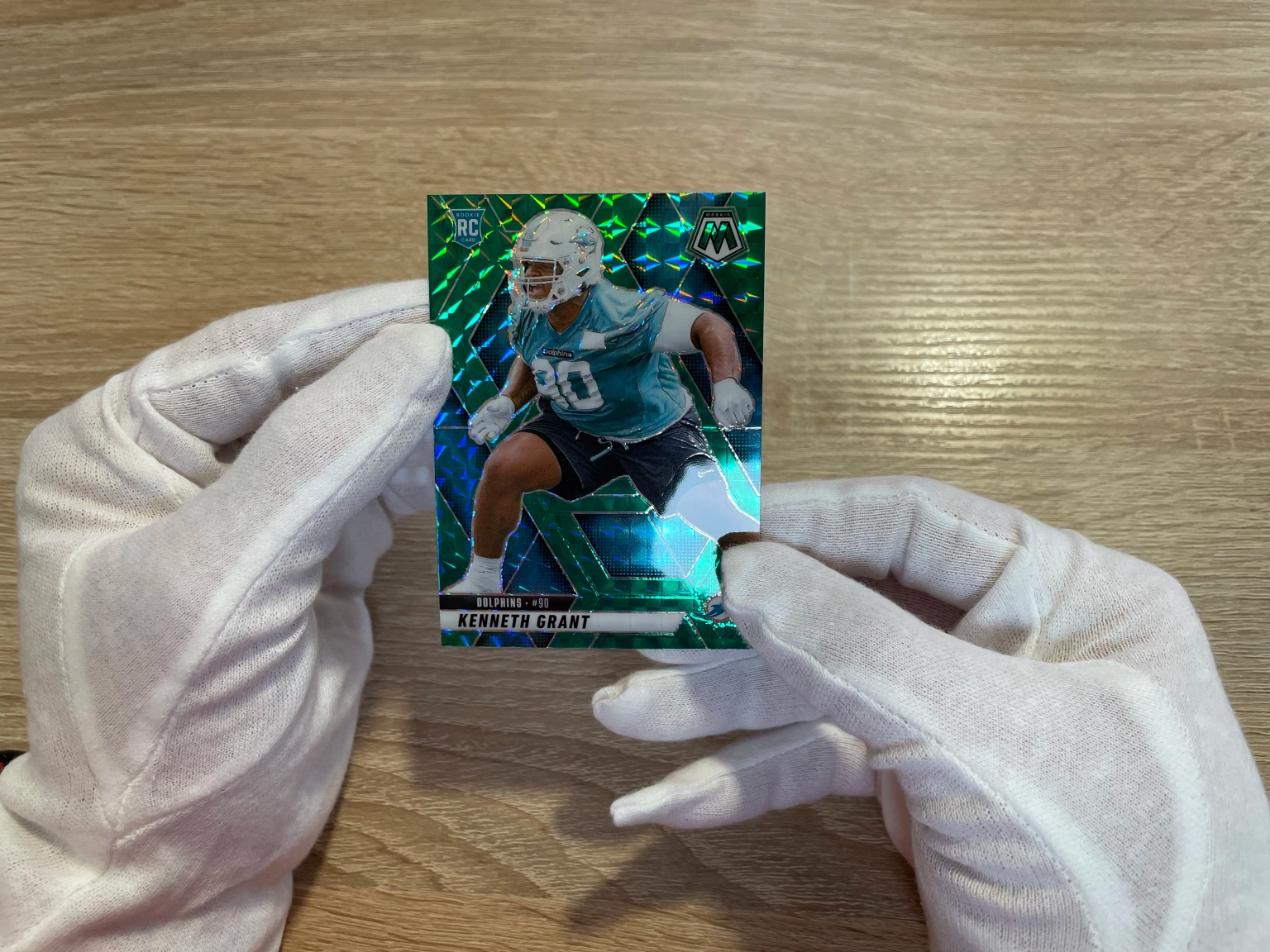 In-hand card inspection setup with gloves and a clean surface