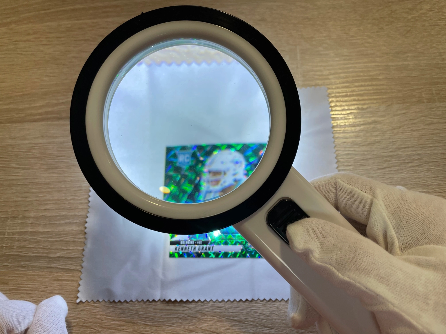 A 10x loupe used to check card corners and surface defects