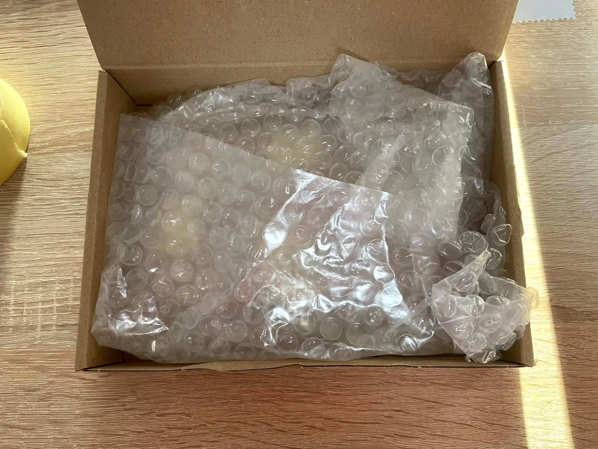 A shipping box with a padded bundle and extra fill material to prevent movement