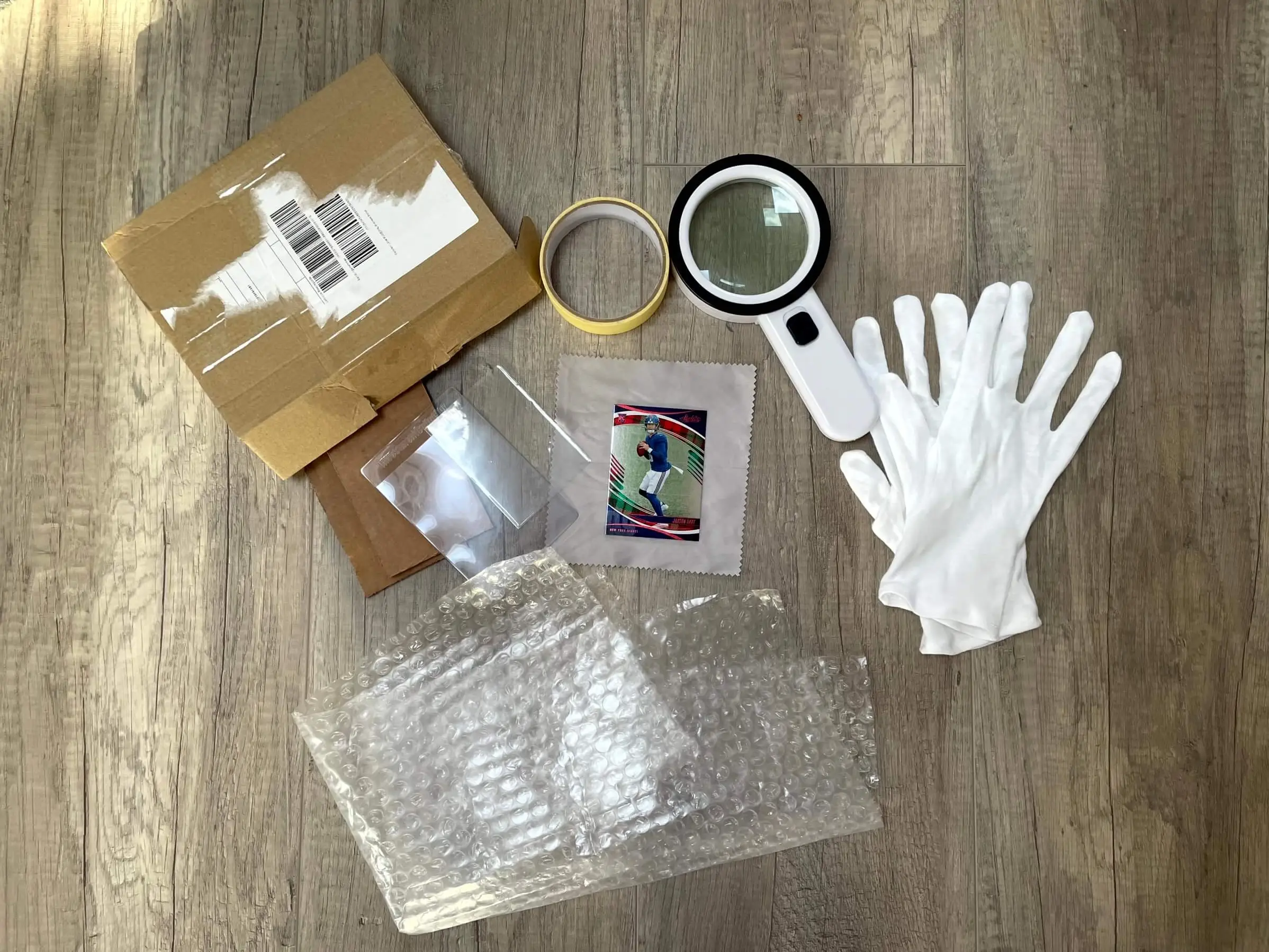 A neat PSA submission setup with cards, sleeves, semi-rigid holders, bubble wrap, and a shipping box