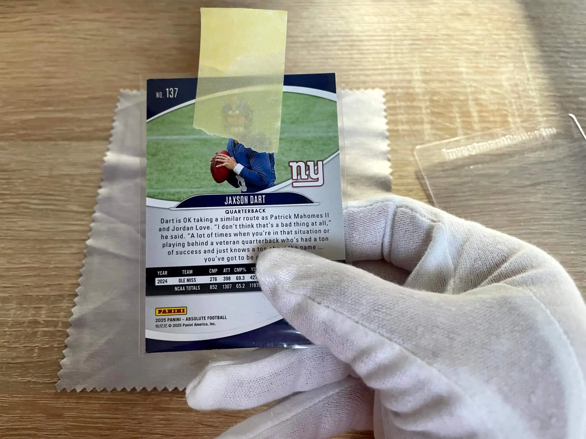 Penny sleeve with a painter tape pull tab attached to the back